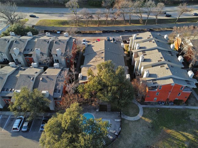 Aerial view of the condominium building, community pool and covered​​‌​​​​‌​​‌‌​‌‌​​​‌‌​​‌‌​‌​​​​​‌ parking | Image 40