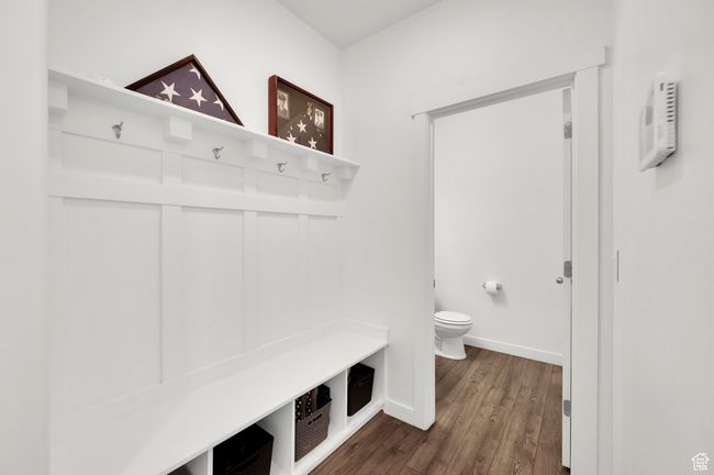 Mudroom with dark wood finished floors and baseboards | Image 11