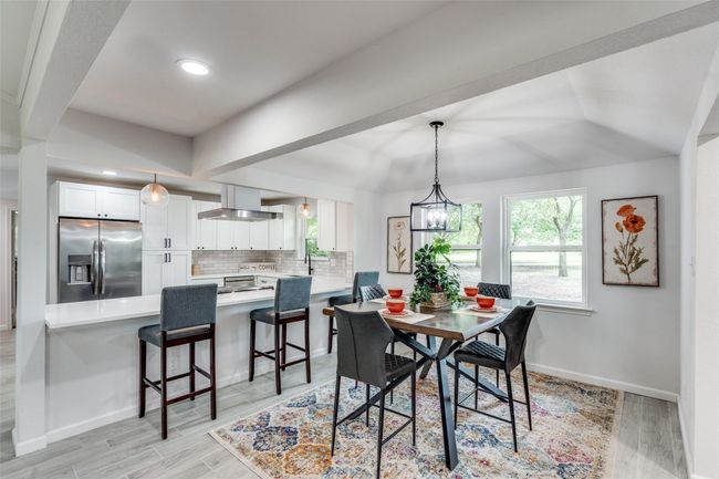 Dining room with wood tiled floors, a chandelier, and recessed lighting | Image 12