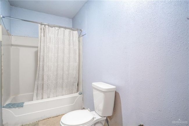 Bathroom with shower / bath combo and a textured wall | Image 8