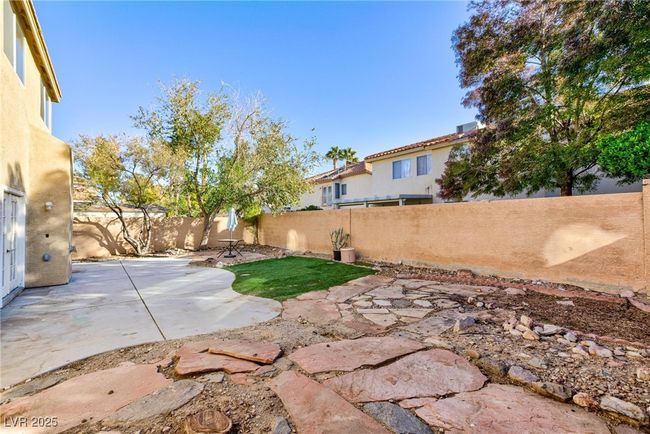 View of yard featuring a patio area and a fenced backyard | Image 45
