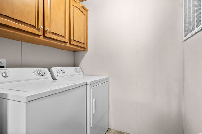 Laundry area with washing machine and dryer and cabinet space | Image 24