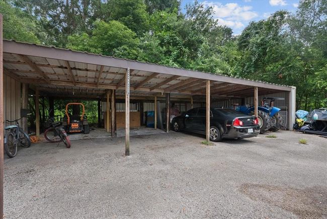 Spacious covered storage area for vehicles, equipment, or extra parking. | Image 50