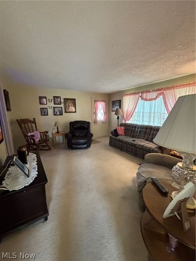 Living room with a textured ceiling | Image 2