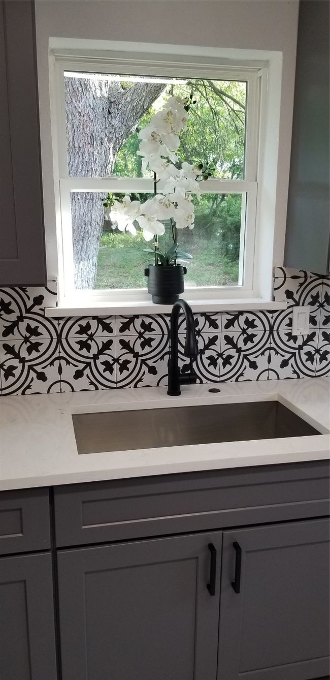 Detailed view of gray cabinets, a sink, and light countertops | Image 8