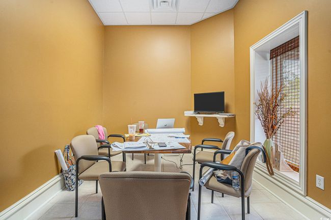 Office area featuring a paneled ceiling, light tile patterned floors, and plenty of natural light | Image 6