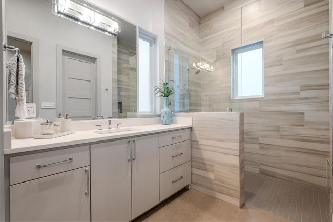 Downstairs ensuite with Full bath with tile patterned floors, vanity, and walk in shower | Image 24