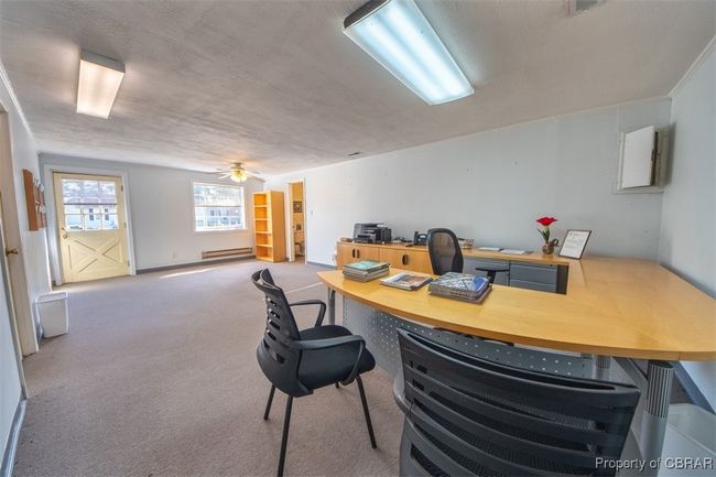 Home office with ceiling fan, carpet flooring, and a baseboard radiator | Image 10