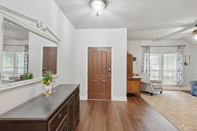 Entrance foyer with dark wood-style floors, ceiling fan, and healthy amount of natural light | Image 6