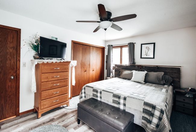 Primary bedroom with new laminate floor, large closet. Room is VERY spacious has king bed, 2 dressers, side tables, bench and a chair! | Image 12