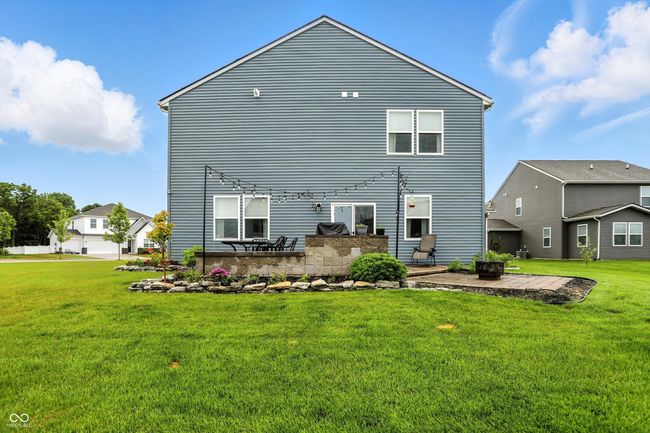 rear view of property featuring a patio area and a lawn | Image 41