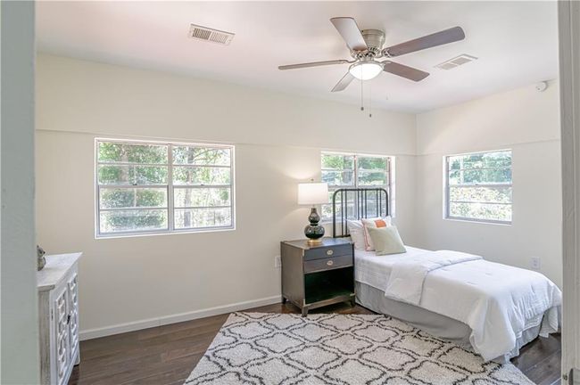 Bedroom featuring dark hardwood / wood-style flooring and ceiling fan | Image 37