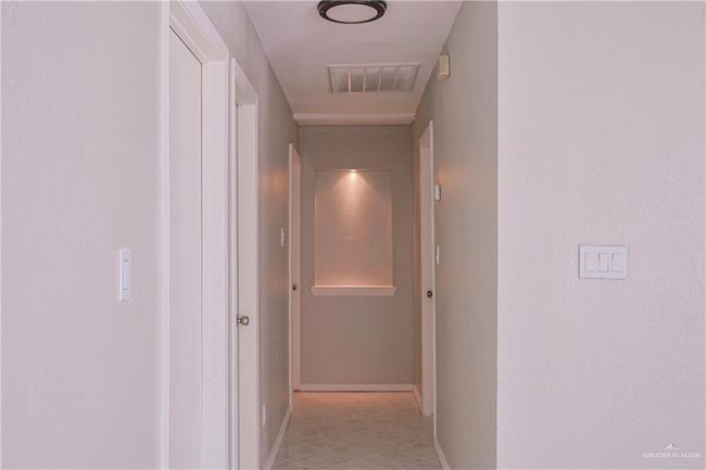Hall featuring visible vents and baseboards | Image 7