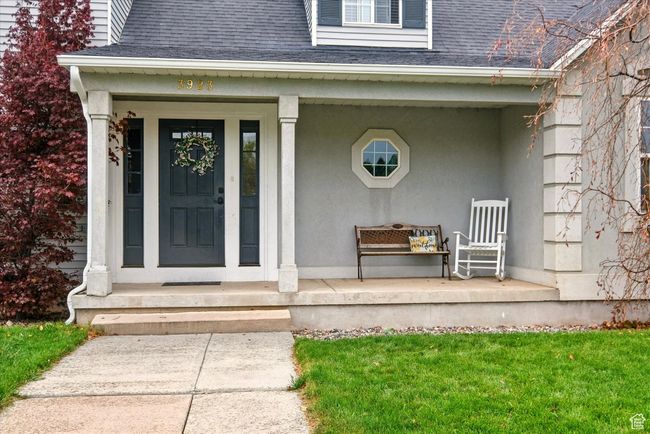 Property entrance featuring a shingled roof and a porch | Image 15