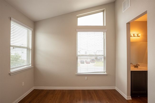 Empty room featuring visible vents, dark wood finished floors, and baseboards | Image 14