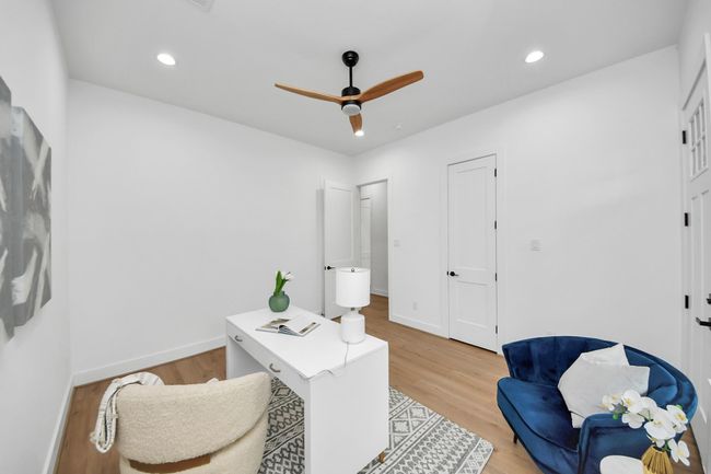 Third bedroom features large windows, ceiling fan, and recessed lighting. | Image 24