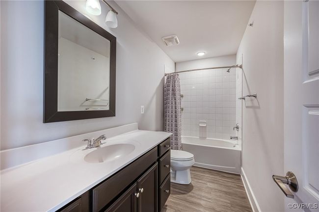 Full bath with vanity, wood finished floors, and shower / bath combination with curtain | Image 21