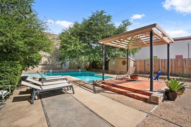 View of swimming pool featuring a shed, a patio, and a fenced backyard | Image 31