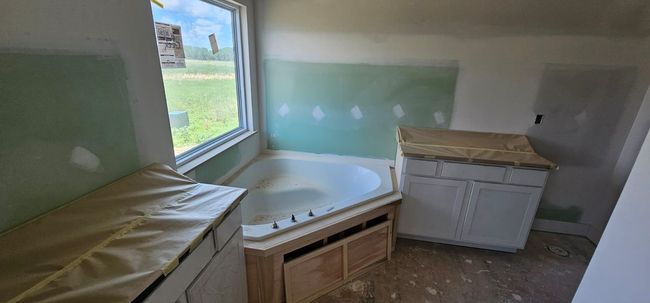 Bathroom featuring a garden tub | Image 9