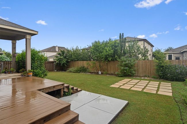 Fenced backyard featuring a patio area and a wooden deck | Image 29