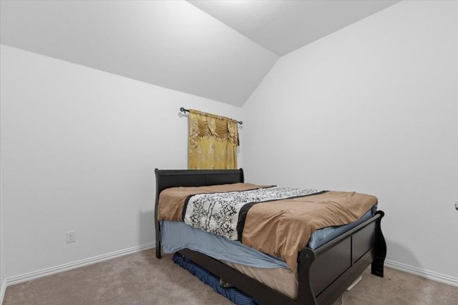 Bedroom with carpet, lofted ceiling, and baseboards | Image 22