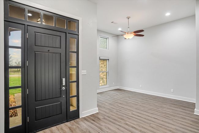 Entryway with wood-type flooring and ceiling fan | Image 31