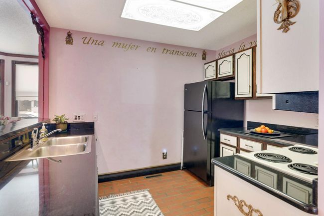 The kitchen has been updated with granite counters and country french detials. | Image 12