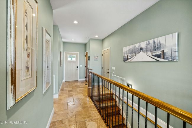 Walkway into the home from the front door and attached garage. Access to all rooms on the main level and beautiful staircase to lower level. | Image 9