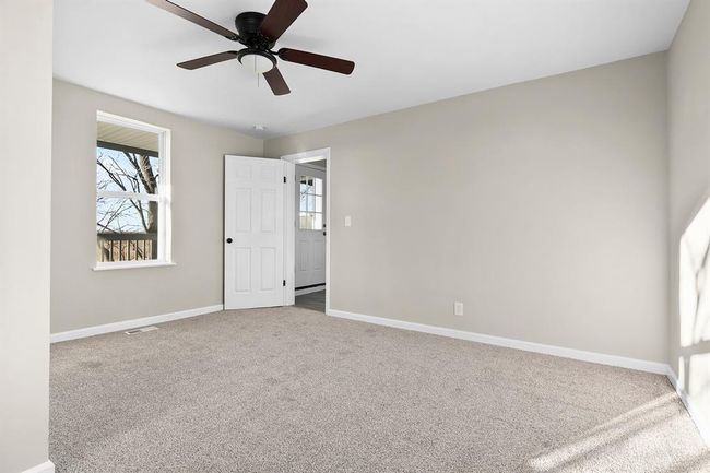 Unfurnished bedroom with carpet floors, baseboards, and a ceiling fan | Image 19