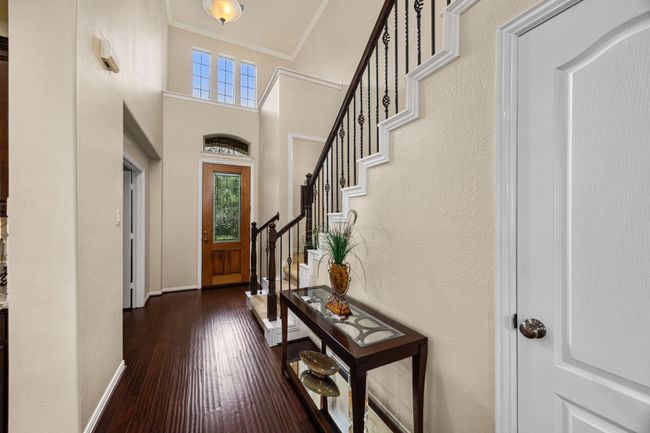 View of the entry, showing the large openness. There is a large hall coat closet, the half bath doorway on the landing and entrance to the office. | Image 7