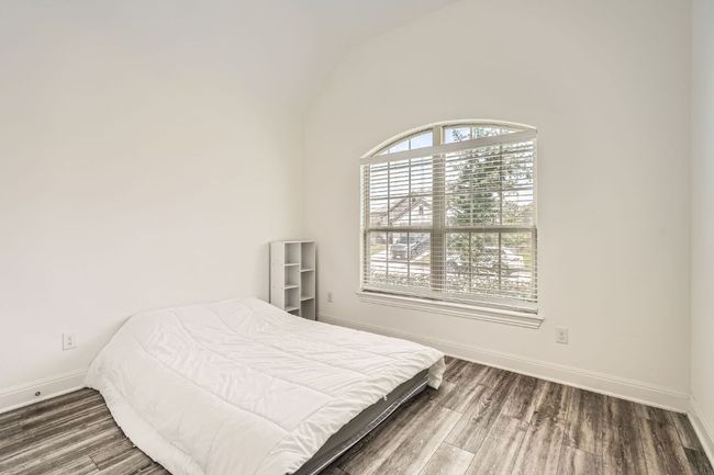 Bedroom featuring vaulted ceiling and wood finished floors | Image 21
