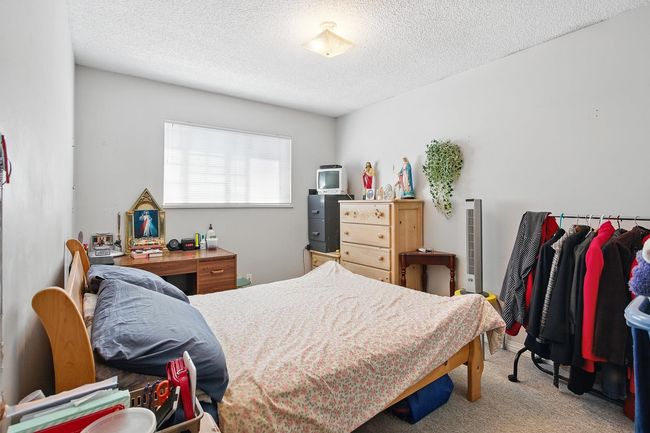 Carpeted bedroom featuring a textured ceiling | Image 18