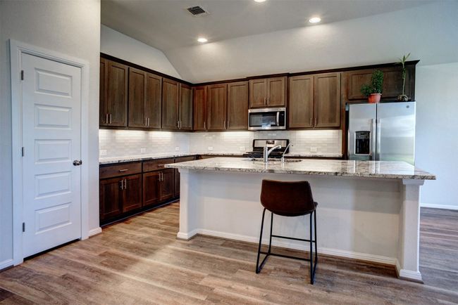 The large kitchen island allows plenty of room for preparing your favorite meal or entertaining guests. | Image 11