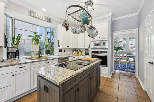 Updated cabinet doors, appliances, granite counter tops, plus so bright and cheery! | Image 11