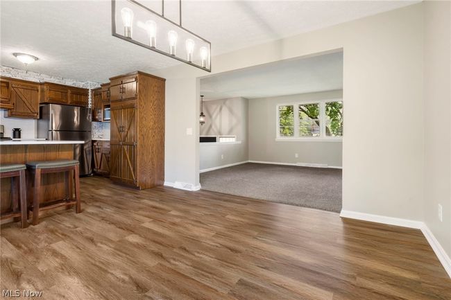 Unfurnished dining area with hardwood / wood-style floors and a chandelier | Image 9