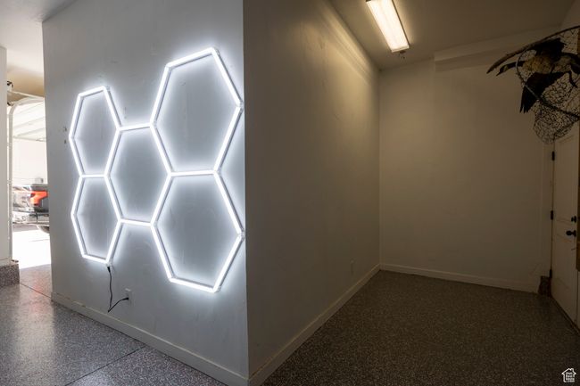 new epoxy floor in main garage with hexagon lights on walls and ceiling. | Image 104