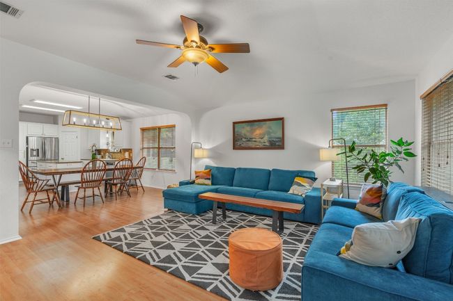 Living room featuring light wood-style floors, ceiling fan, and vaulted ceiling | Image 17