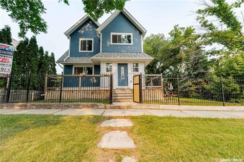 Two-story residence featuring blue siding and white trim | Card Image