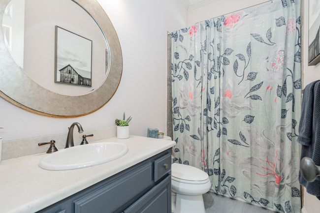 Bathroom featuring a shower with curtain, crown molding, vanity, and toilet | Image 13
