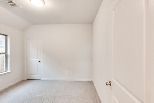 Unfurnished room with light carpet, baseboards, and vaulted ceiling | Image 23