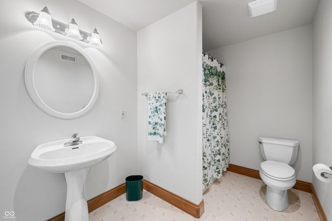 bathroom with visible vents, toilet, a shower with curtain, and baseboards | Image 103