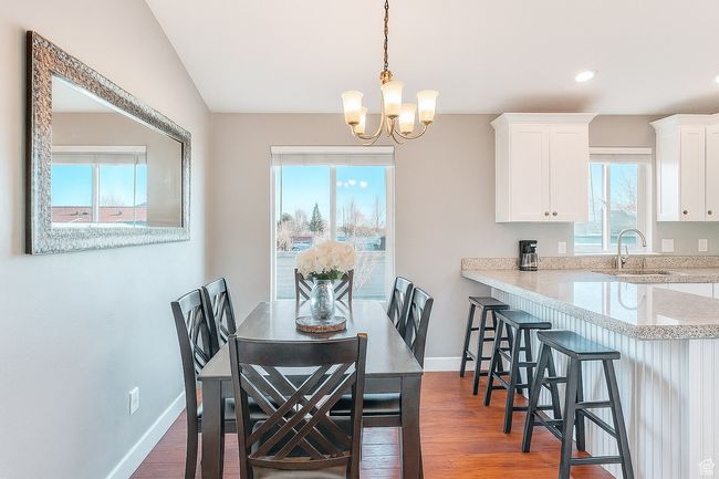Dining room with a chandelier, wood finished floors, and recessed lighting | Image 7