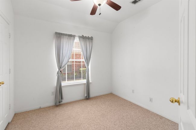 Unfurnished room with carpet, ceiling fan, vaulted ceiling, and baseboards | Image 34