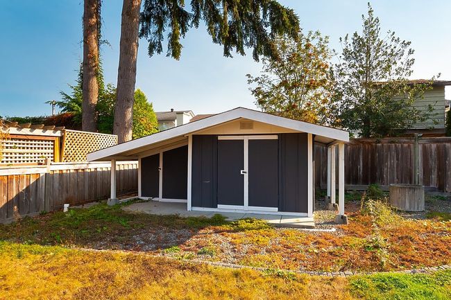 View of outdoor structure with a fenced backyard | Image 36