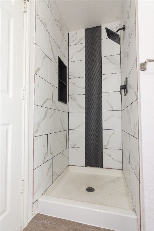 Primary Bath also offers updated tile | Image 18