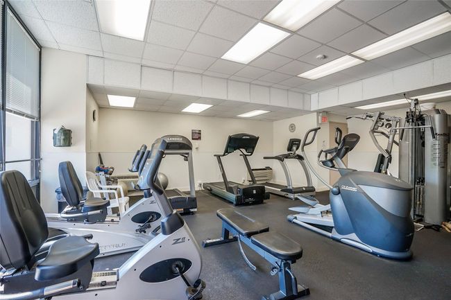 Workout area featuring a paneled ceiling | Image 33