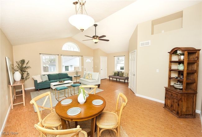 Dining area featuring plenty of natural light, light wood-style flooring, visible vents, and ceiling fan | Image 8