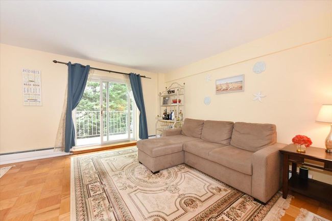 Living room featuring baseboard heating | Image 8