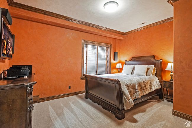Carpeted bedroom featuring visible vents, baseboards, and crown molding | Image 43