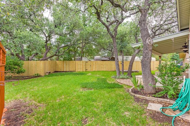 Fenced backyard featuring a ceiling fan | Image 33
